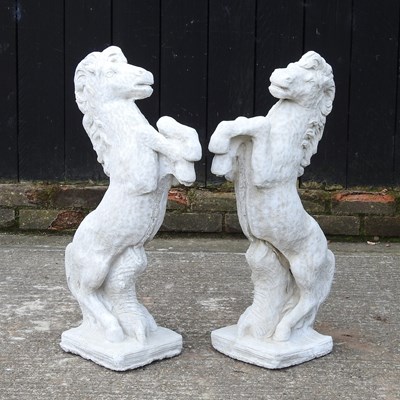 Lot 333 - A pair of cast stone garden statues of rearing...