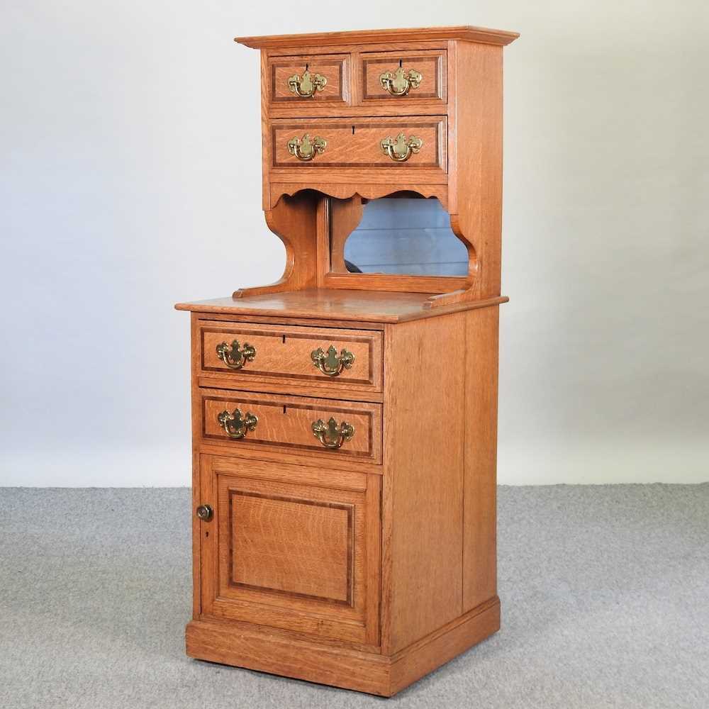 Lot 659 - An early 20th century light oak side cabinet