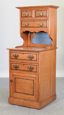 Lot 659 - An early 20th century light oak side cabinet