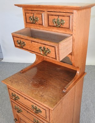 Lot 659 - An early 20th century light oak side cabinet