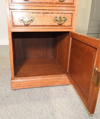 Lot 659 - An early 20th century light oak side cabinet