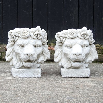 Lot 128 - A pair of cast stone lion mask garden planters,...