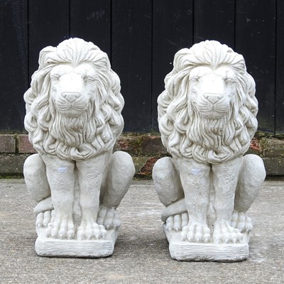 Lot 29 - A pair of cast stone garden statues of seated...