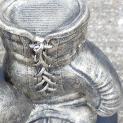 Lot 170 - A cast stone garden sculpture of boxing gloves,...