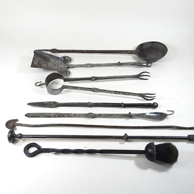 Lot 369 - A collection of forged steel fire tools