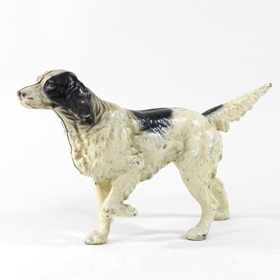 Lot 15 - A painted cast iron door stop, in the form of...