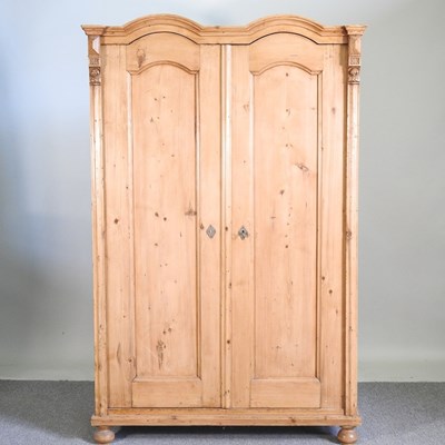 Lot 498 - An antique French pine armoire, enclosed by a...