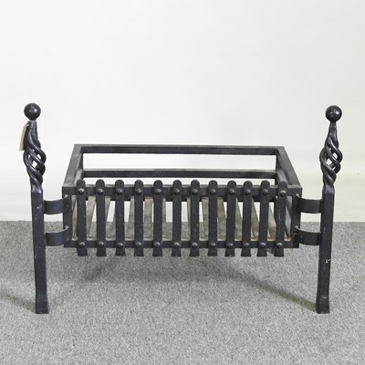 Lot 211 - A black painted cast iron blacksmith-made fire...