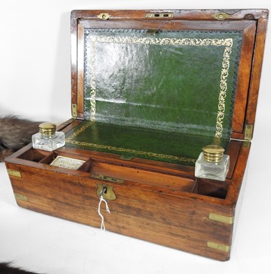 Lot 124 - A Victorian walnut and brass bound writing...