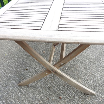 Lot 146 - A teak folding garden table, on splayed legs
