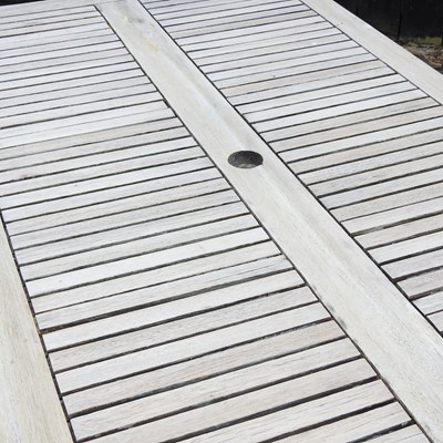 Lot 146 - A teak folding garden table, on splayed legs