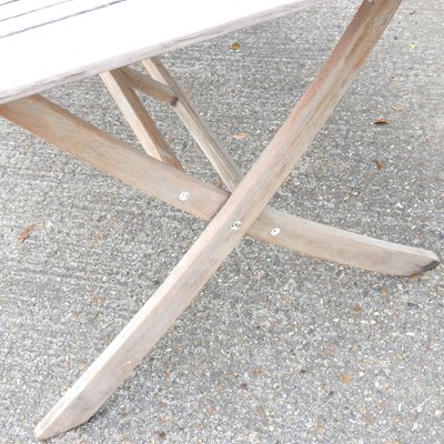 Lot 146 - A teak folding garden table, on splayed legs