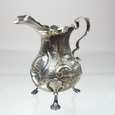 Lot 210 - A George III silver cream jug, with later...