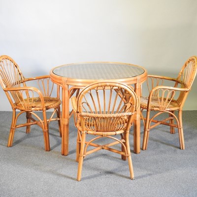 Lot 126 - A bamboo circular dining table, with a glass...