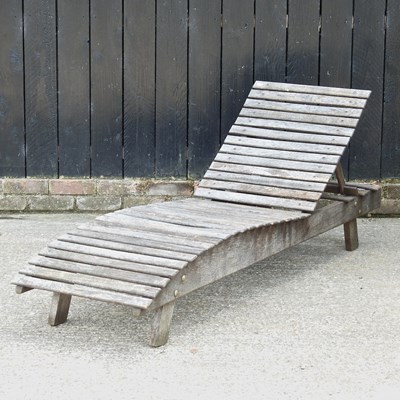 Lot 43 - A teak adjustable garden lounger, 183cm long