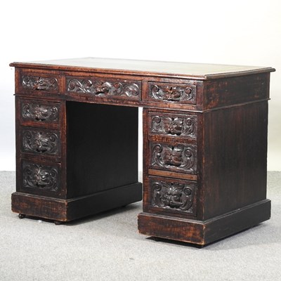 Lot 679 - A late 19th century heavily carved dark oak pedestal desk