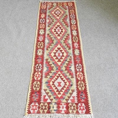 Lot 491 - A Persian kelim runner, with a row of four...