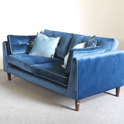 Lot 435 - A Sofology blue velvet upholstered sofa, with...