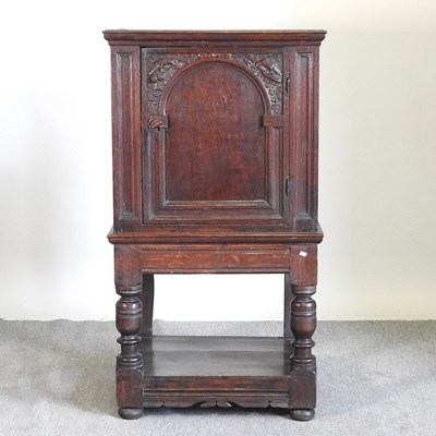 Lot 292 - A 17th century style carved dark oak cupboard,...