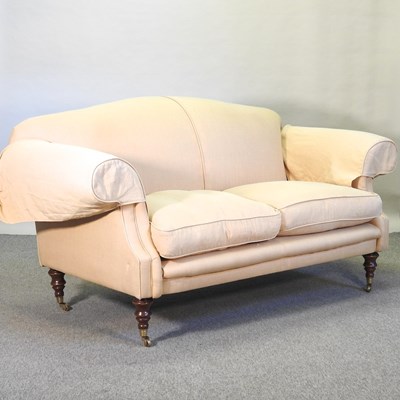 Lot 641 - A beige upholstered two seater sofa