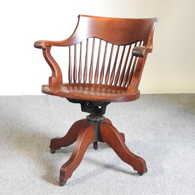 Lot 197 - An early 20th century oak swivel desk chair,...