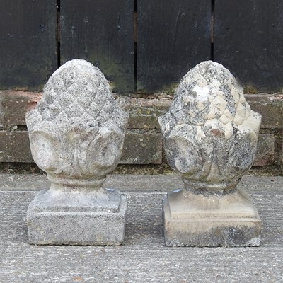 Lot 208 - A pair of cast stone pineapple shaped garden...