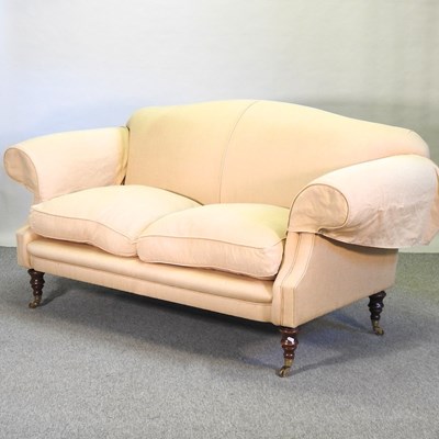 Lot 646 - A beige upholstered two seater sofa