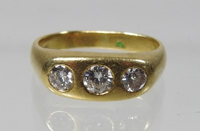 Lot 19 - An 18 carat gold three stone diamond ring