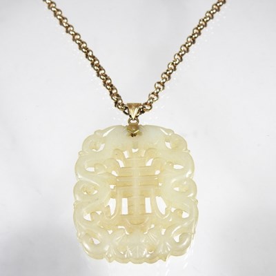 Lot 42 - A Chinese jade pendant, fret carved with two...