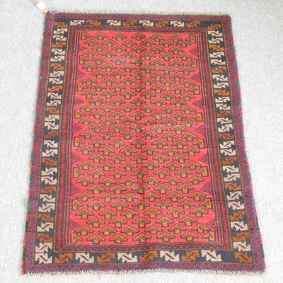 Lot 219 - A baluchi rug, with all over design, on a red...