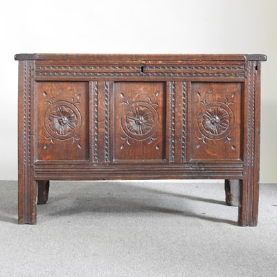 Lot 479 - An 18th century carved oak coffer, with a...