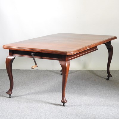 Lot 486 - A 1920's mahogany wind out extending dining...