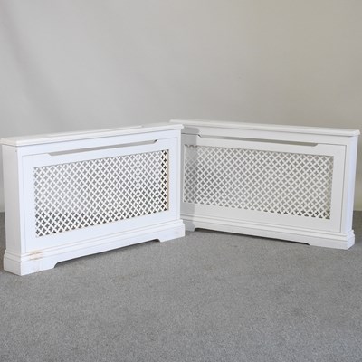 Lot 105 - A pair of white painted wooden radiator covers...