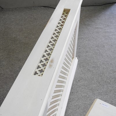 Lot 105 - A pair of white painted wooden radiator covers...