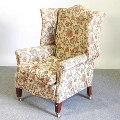 Lot 629 - An early 20th century floral upholstered wing...