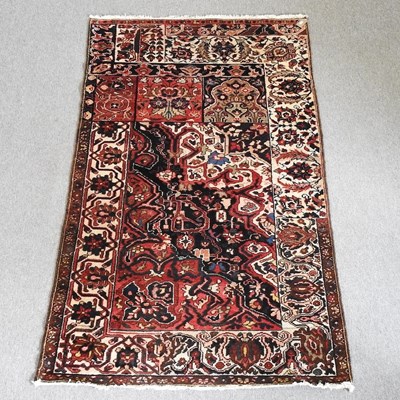 Lot 141 - A Hamadan rug, with all over designs, on a red...