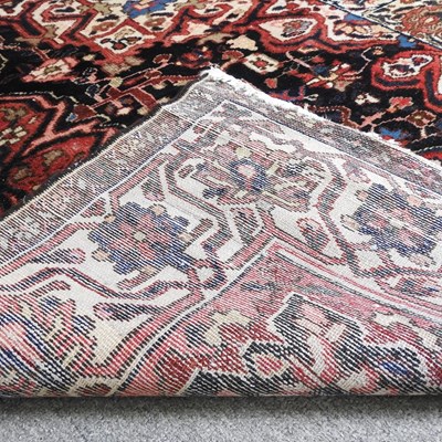 Lot 141 - A Hamadan rug, with all over designs, on a red...