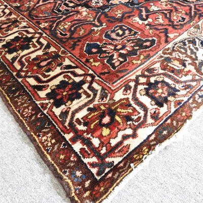 Lot 141 - A Hamadan rug, with all over designs, on a red...