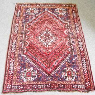 Lot 120 - A Persian Shiraz rug, with a central hooked...