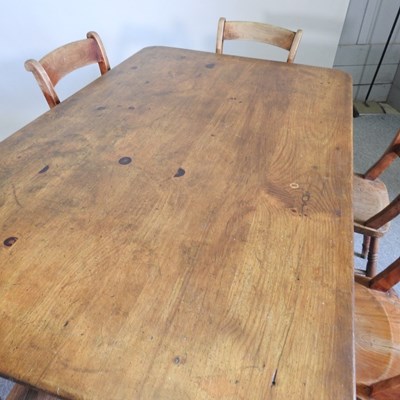 Lot 125 - A pine dining table, on turned legs, together...