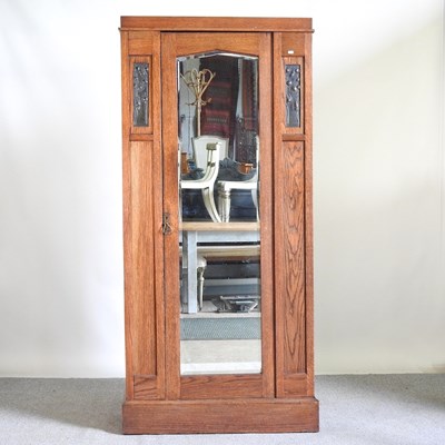 Lot 438 - An Arts and Crafts oak single wardrobe, with a...