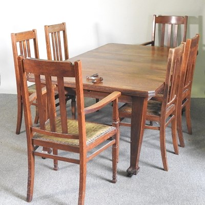 Lot 344 - An Edwardian oak wind-out extending dining...