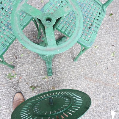 Lot 149 - A green painted cast iron garden table, 56cm...