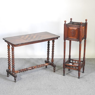 Lot 243 - A Victorian inlaid games table, on bobbin...