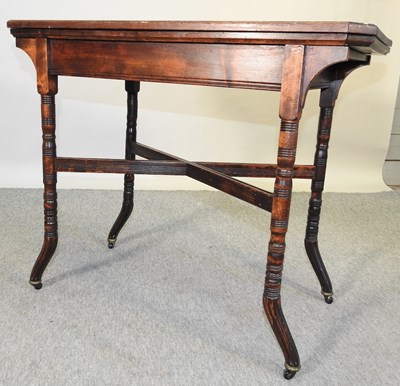 Lot 688 - An Edwardian folding card table, on turned legs