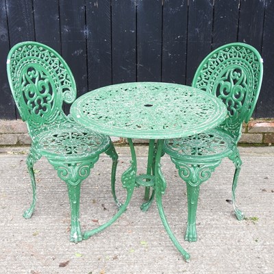 Lot 404 - A metal garden table, together with two...