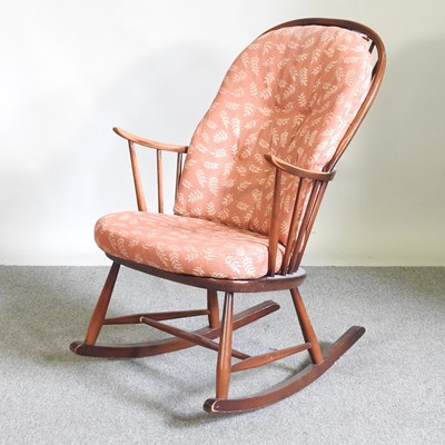 Lot 303 - A 1970's Ercol dark elm rocking chair, with...