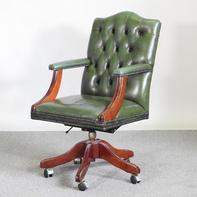 Lot 273 - A green leather upholstered swivel desk chair