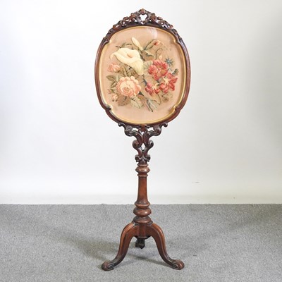 Lot 489 - A Victorian carved walnut fire screen, with an...