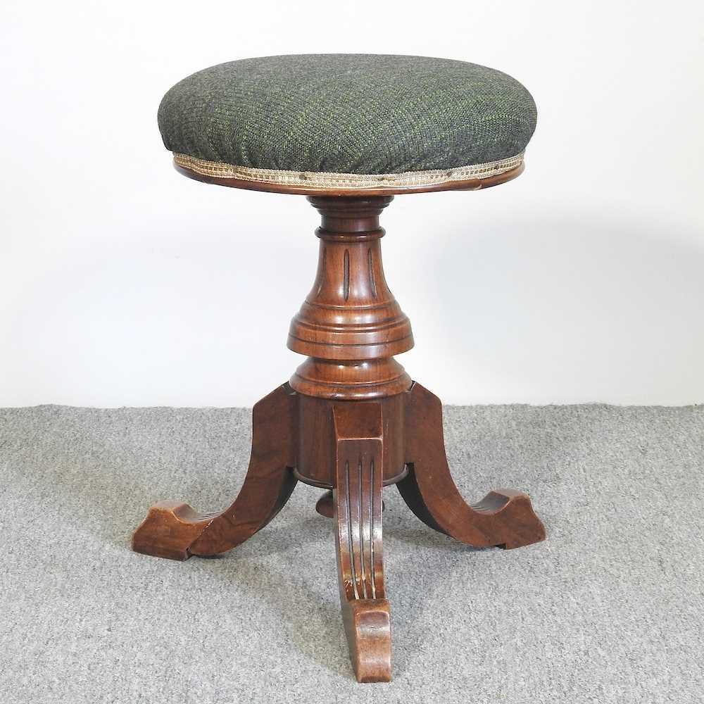 Lot 135 - A Victorian walnut revolving piano stool,...